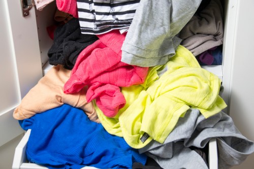 Workers loading waste into a van in a retail area